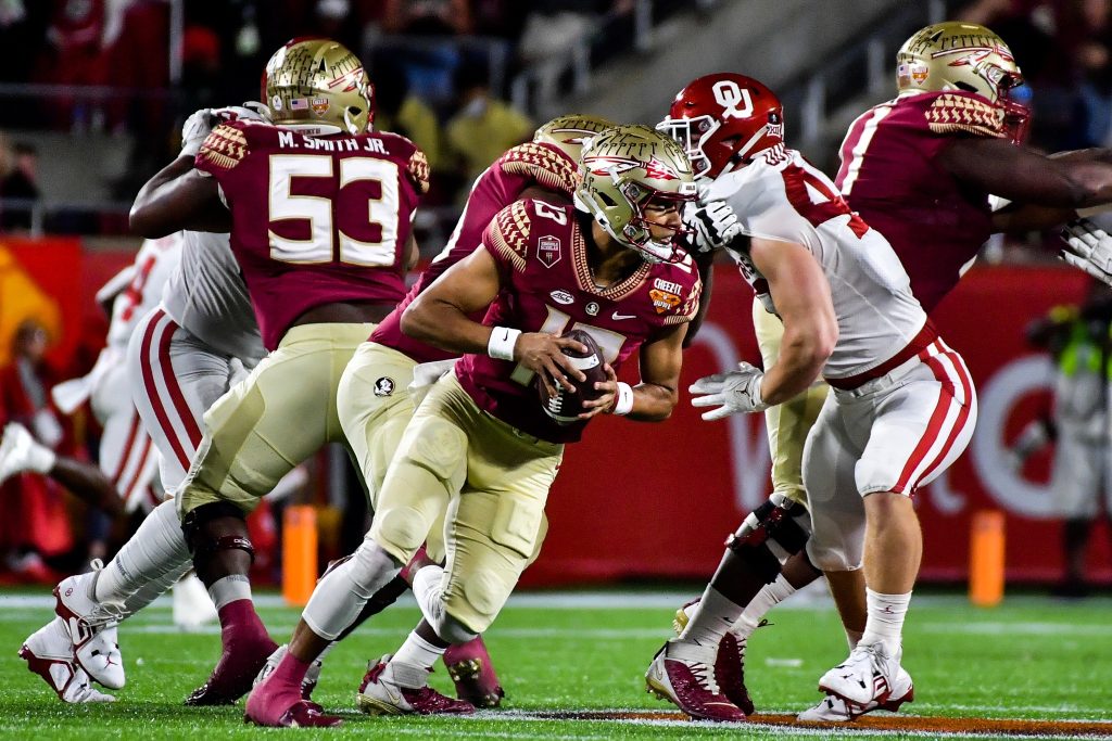Florida State quarterback Jordan Travis (#13) takes on the Oklahoma Sooners defense in the 2022 Cheez-It Bowl in Orlando, Thursday, December 29, 2022. Photo by Harry Castiblanco / Florida National News.